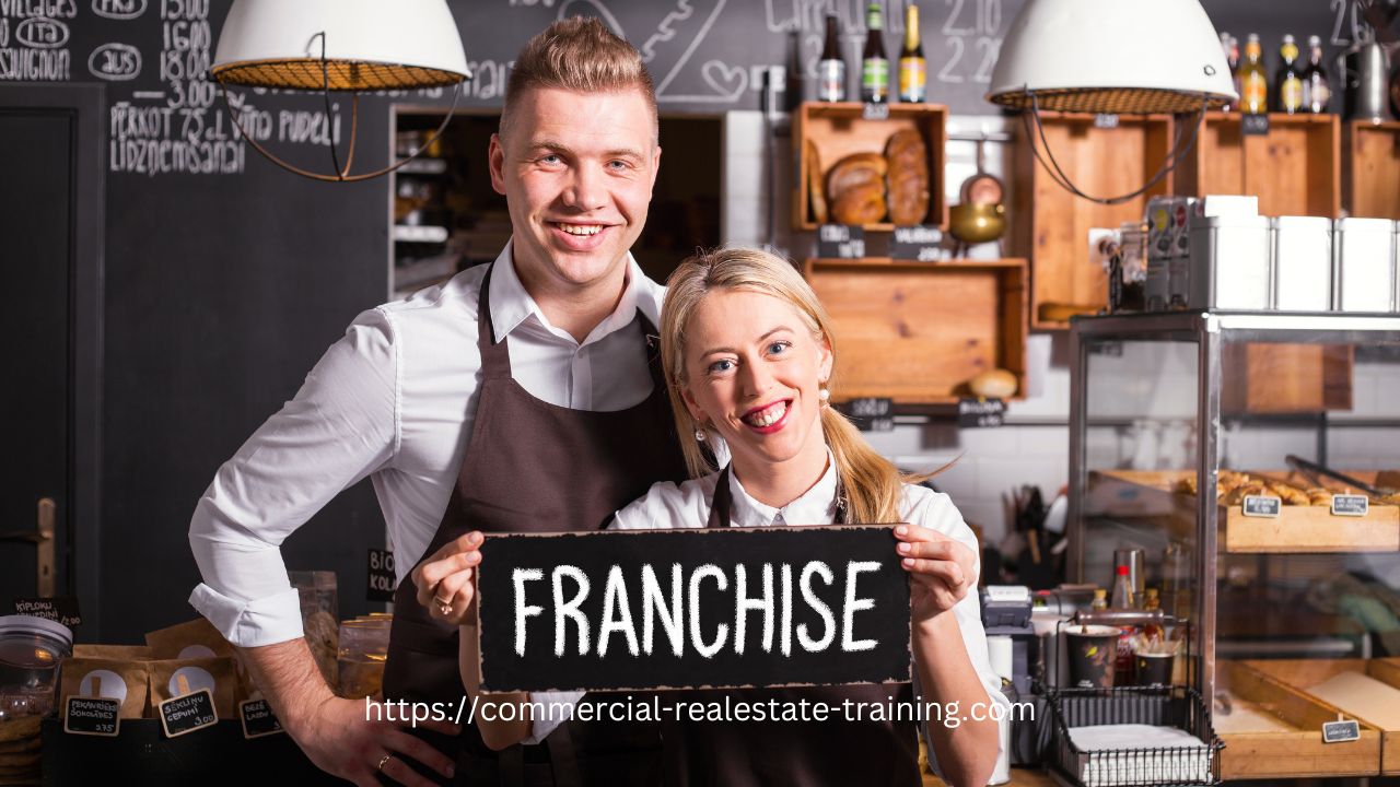 man and woman holding franchise sign