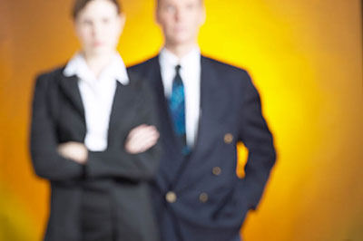 two business people standing in blur