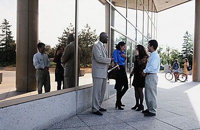 people standing in group outside of building