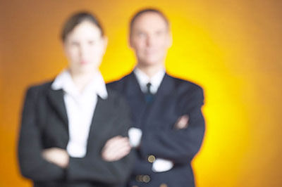 two blurred business people standing